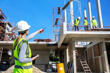 The engineer talks to the contractor to supervise and plan the work.